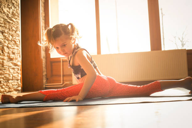 istock Little girl workout at home. 639632576