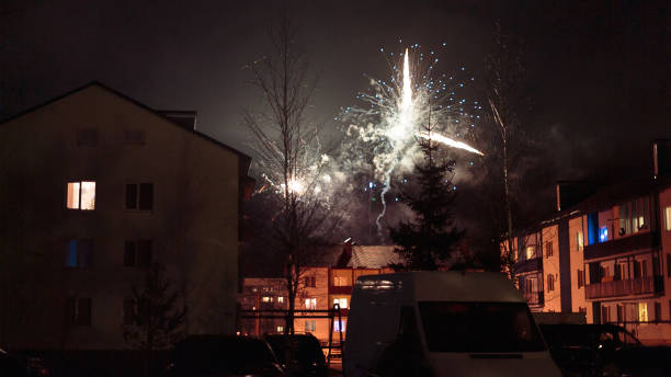 istock fireworks in the night sky over houses 639633320
