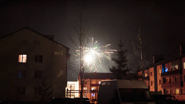 istock fireworks in the night sky over houses 639635220