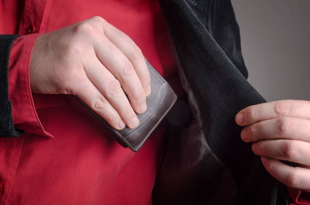 istock Business man put his leather wallet into his jacket pocket 639635472