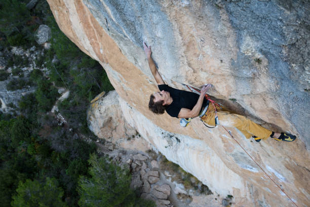 istock Extreme sport climbing. Young male rock climber. 639638510
