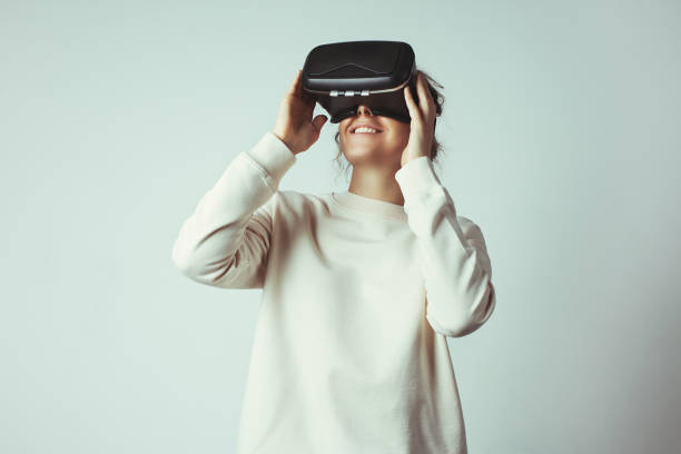 Handsome young woman wearing virtual headset