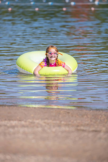 Girl Playing In Inner Tube Float at Beach