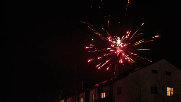 istock fireworks in the night sky over houses 639643906