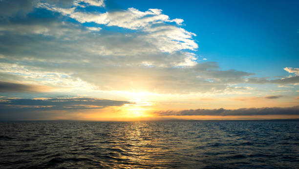 istock beautiful sunset through the  clouds over the sea 639644224