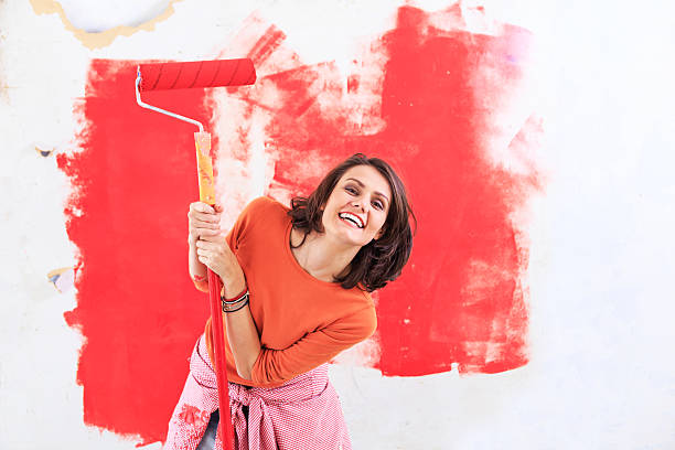 Smiling woman having fun and decorating