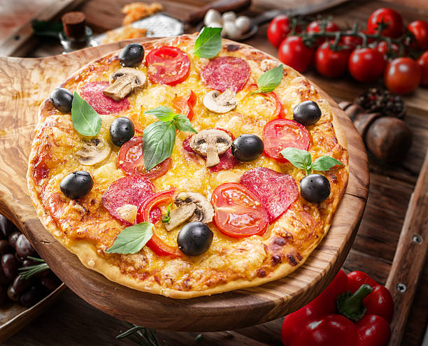 istock Pizza with mushrooms, salami and tomatoes. 639646580