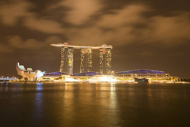 Singapore, Singapore - April 10, 2016: Night view of the Marina Bay Sands Hotel in Singapore in the centre. The ArtScience Museum is showing to the left.
