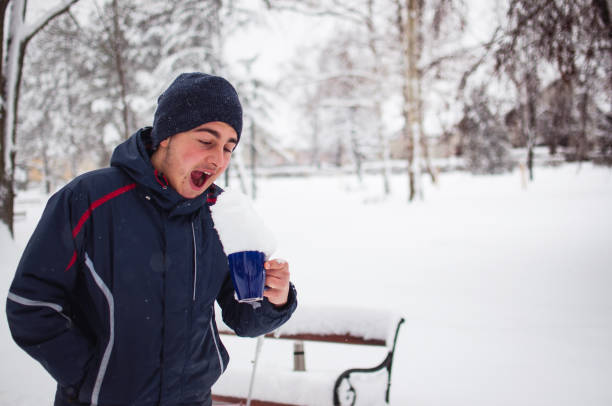 istock The boy who drinks from a cup snow 639653476