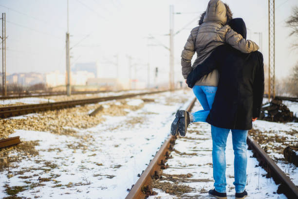istock Strong man holding his girlfriend on the railroad 639655246