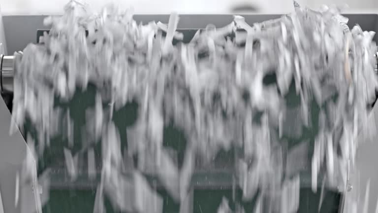 Shredded paper falling from the conveyor belt