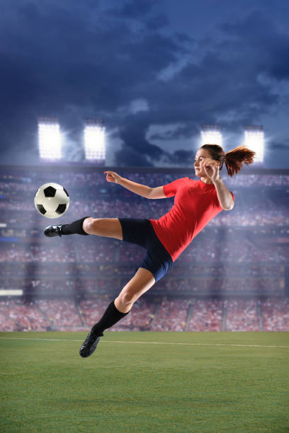 istock Female Soccer Player Kicking Ball 639657416