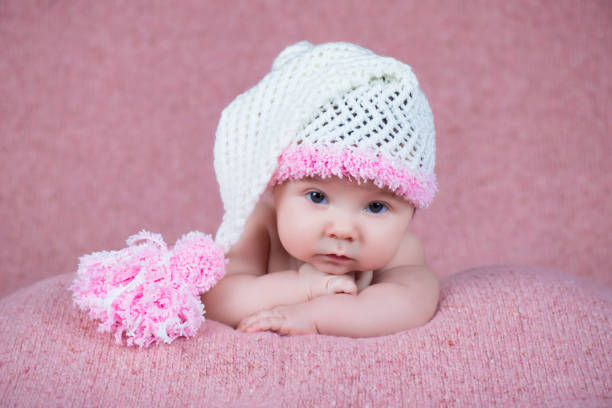 istock Newborn baby in a warm knitted hat. 639657472