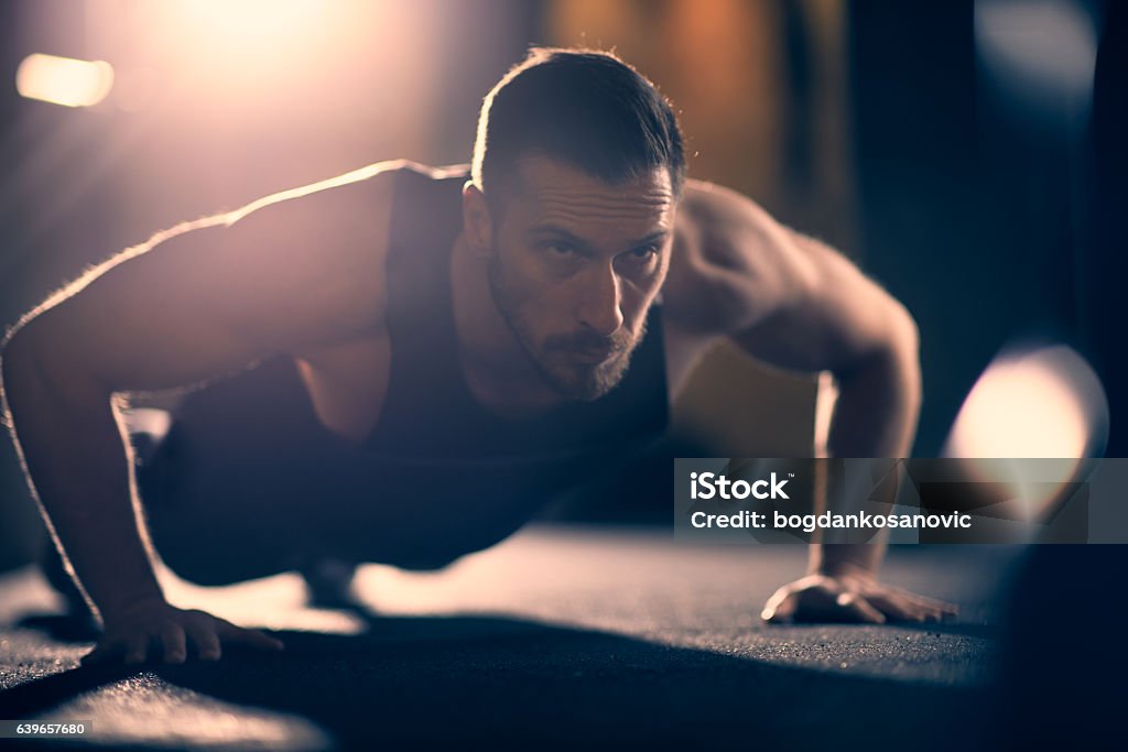 Push ups on floor Caucasian athlete doing push-ups on floor Men Stock Photo