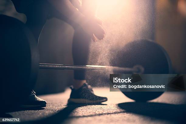 Preparing To Lift Dumbell In A Gym Stock Photo - Download Image Now - Cross Training, Gym, Sports Chalk