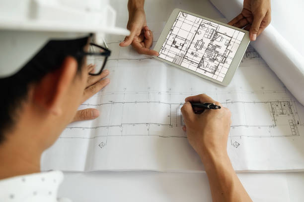 istock Hands of Engineer working on blueprint 639662602