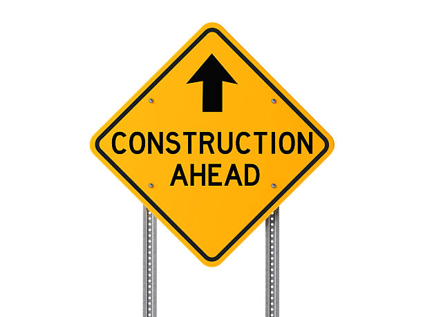 Yellow Construction Ahead Sign Isolated On White Background High quality 3d render of a yellow construction ahead sign isolated on white background. Clipping path is included. Horizontal composition with copy space. construction zone signs stock pictures, royalty-free photos & images