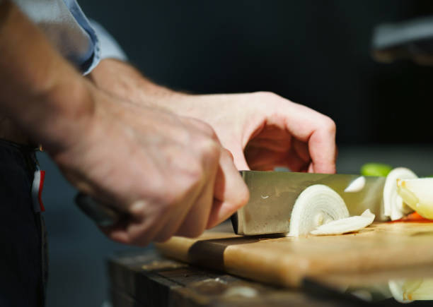istock Chef cuts onion with a knife 639679898