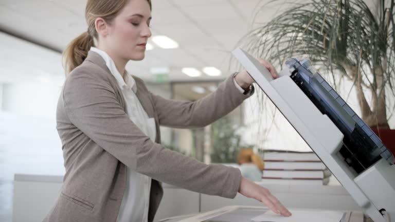 Woman using the copying machine in the office