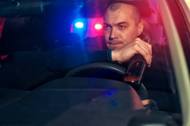 istock Young drunk man with beer bottle chased by police 639683678