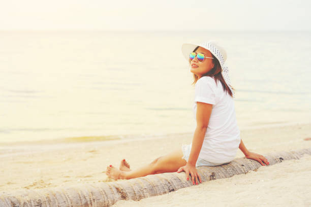 istock Young lady sitting on the trunk 639684782