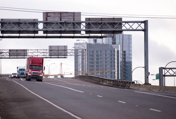 istock Caravan of semi trucks going by wide interstate highway 639684952