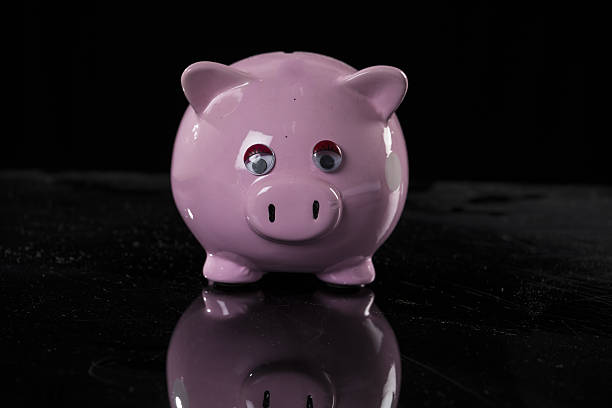 istock Pink piggy bank on black backbround 639687294