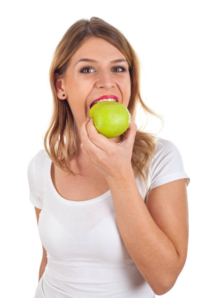 istock Young woman eating an apple 639689486