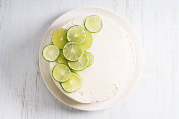 istock sweet white buttercream cake with sliced lime on top 639689638