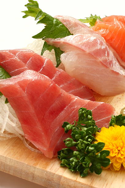 Mixed Raw Fish Sashimi Platter on Wooden Plate , Japanese food Assorted sashimi (tuna, red sea bream, salmon) taken in close-up. salmon and red snapper stock pictures, royalty-free photos & images