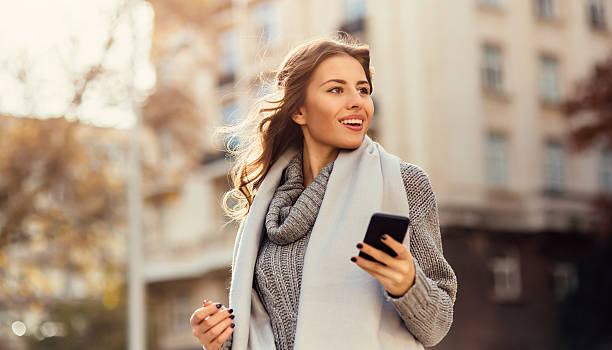 istock Young woman texting outdoors 639694844