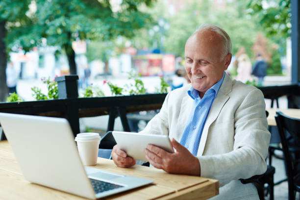 istock Pleased Senior Looking at Tablet Screen 639694922