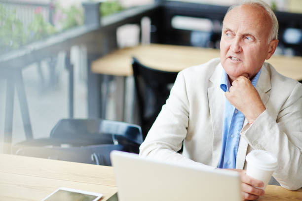 istock Concerned Mature Businessman in Cafe 639694936