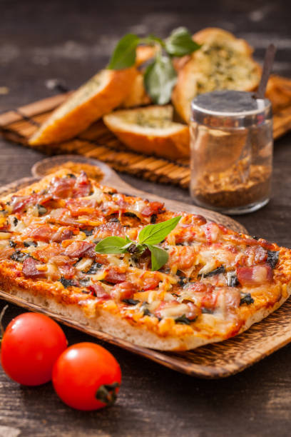 istock Homemade bacon pizza with garlic bread 639695368