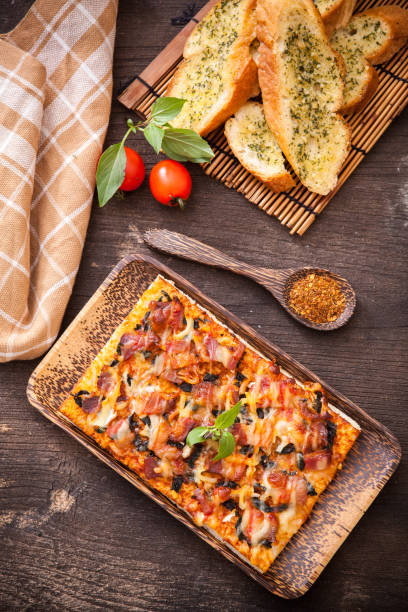 istock Homemade bacon pizza with garlic bread 639697404