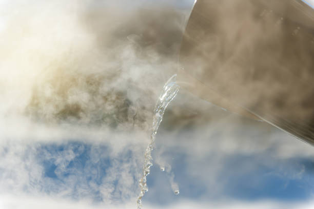 Pouring hot water in winter at sunset