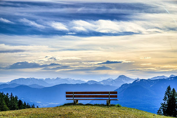 bench at a mountain bench on the blomberg mountain in bavaria tranquil scene stock pictures, royalty-free photos & images