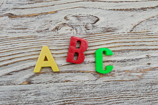 istock ABC spelling from the plastic letters on wood background 639700676