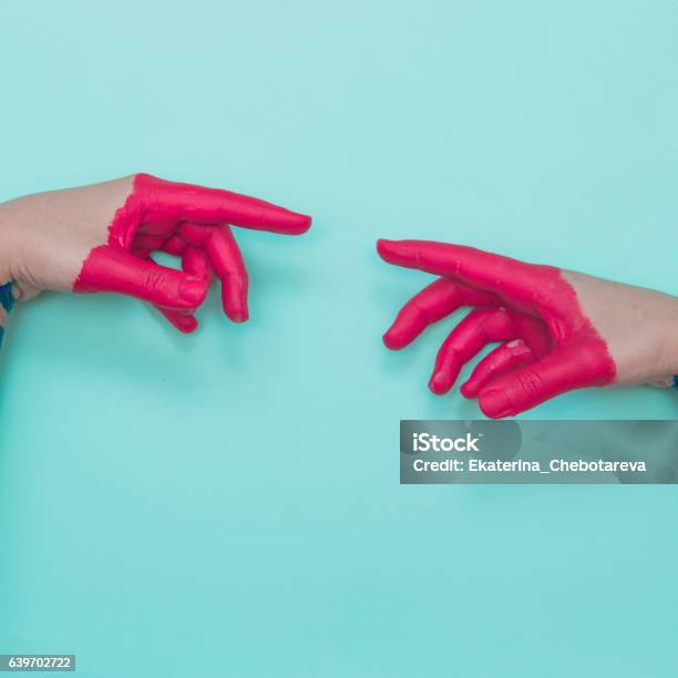 Two Painted Hands Stock Photo - Download Image Now - Paint, Magenta, Colors
