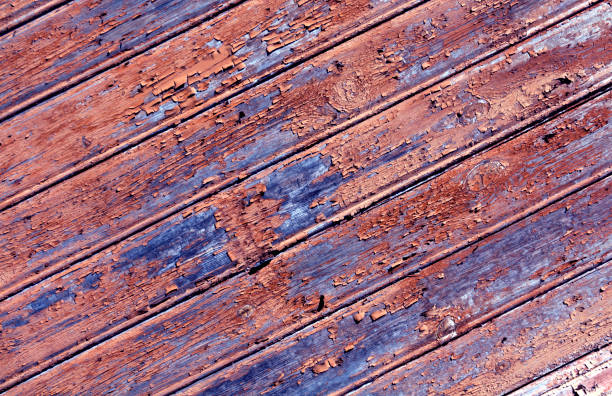 Weathered orange painted wooden wall texture.