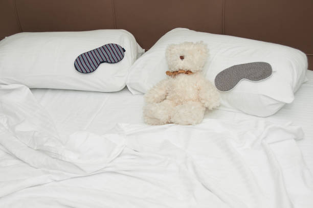 istock Teddy bear and sleep mask on the cozy bed. 639706830