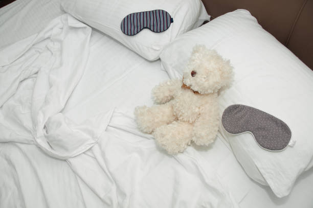 istock Teddy bear and sleep mask on the cozy bed. 639706850