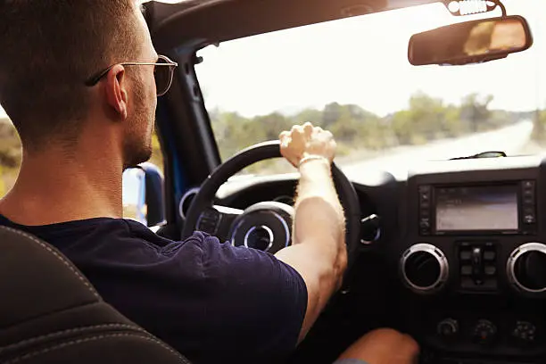 Photo of Man Driving Open Top Car On Country Road