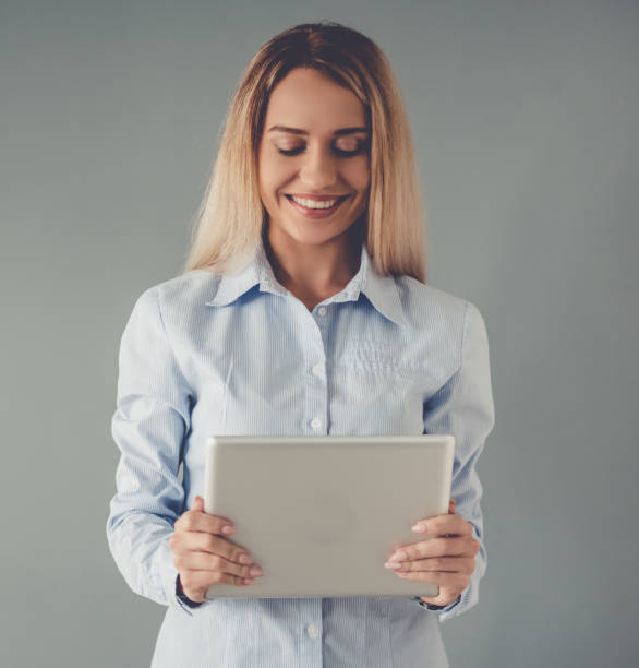 istock Beautiful business lady with gadget 639708602