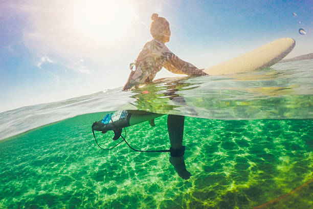 istock Surfer girl floating on a surfboard 639709244