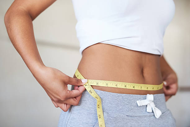 You can get the same results Cropped shot of a young woman measuring her waist in the bathroom diets stock pictures, royalty-free photos & images