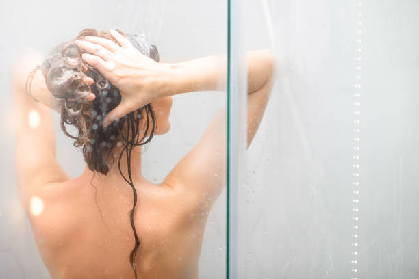istock Young woman showering 639710688