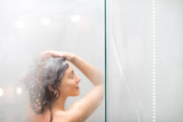 istock Young woman showering 639710858