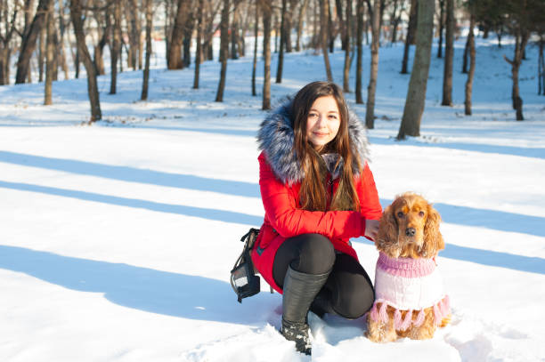 istock Young woman with cocker spaniel dog in winter park 639711670