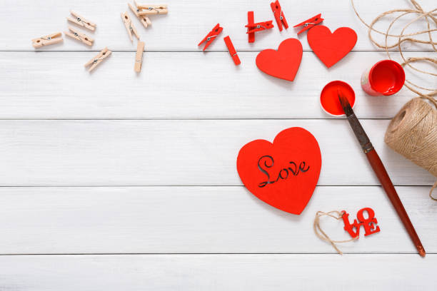 istock Valentine day diy handmade hearts making, top view on wood 639712344